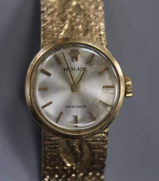 A ladys 9ct gold Rolex Precision manual wind wrist watch, on a fancy 9ct Rolex bracelet.
